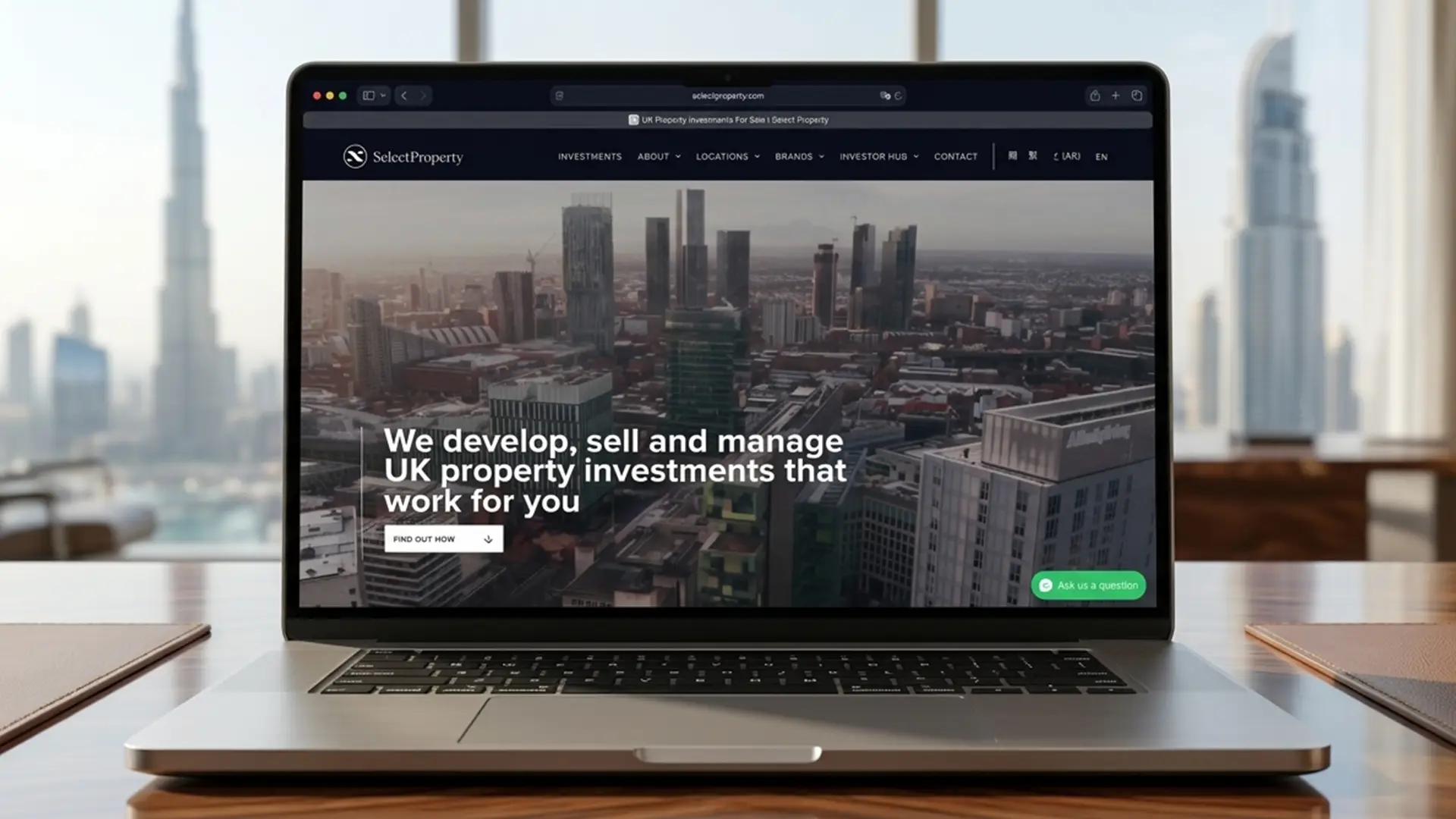 The website on a laptop, with Dubai behind